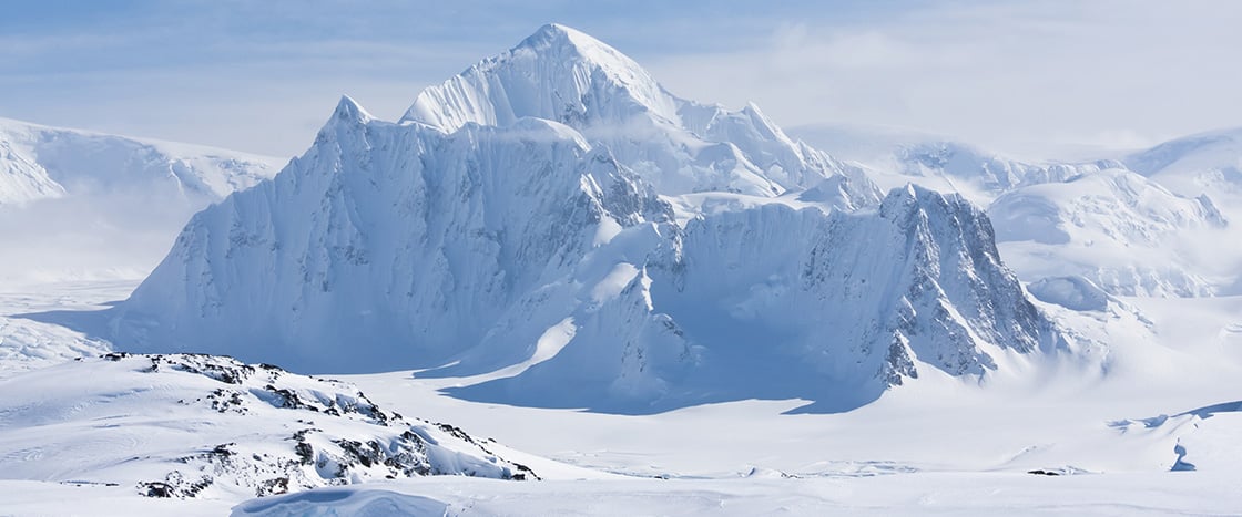 Photo showing a snowy mountain range