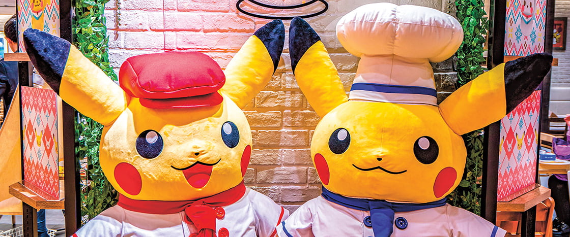 Image of two people wearing Pikachu costumes